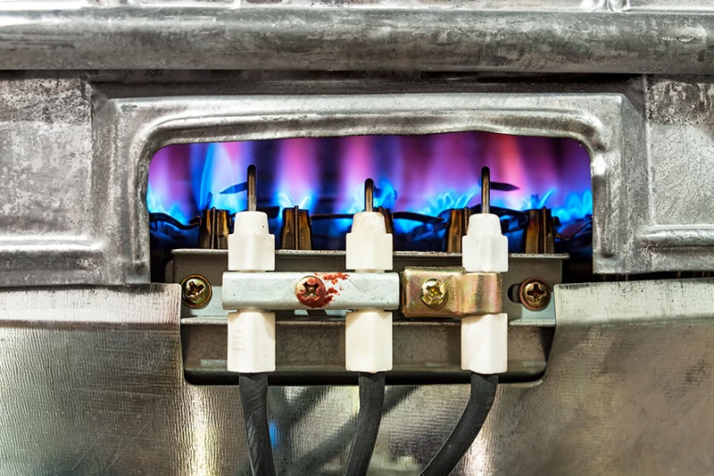 close-up of a gas furnace pilot flame.